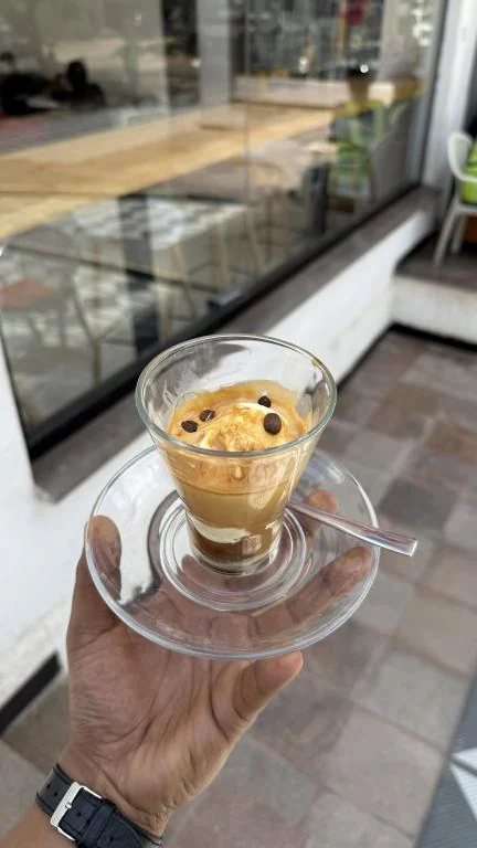 Affogato in a glass cup with coffee beans