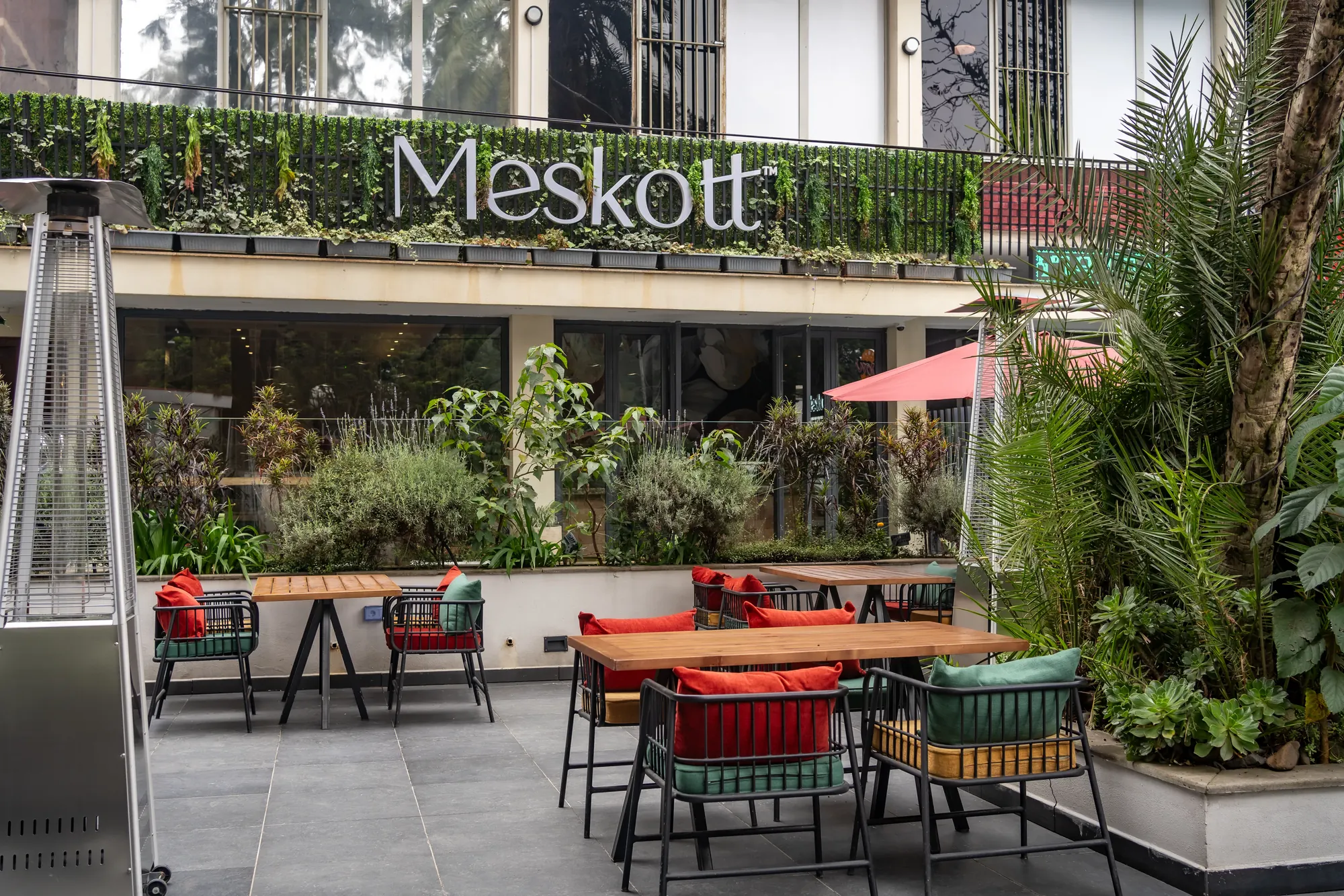 Garden terrace tables under the Meskott sign