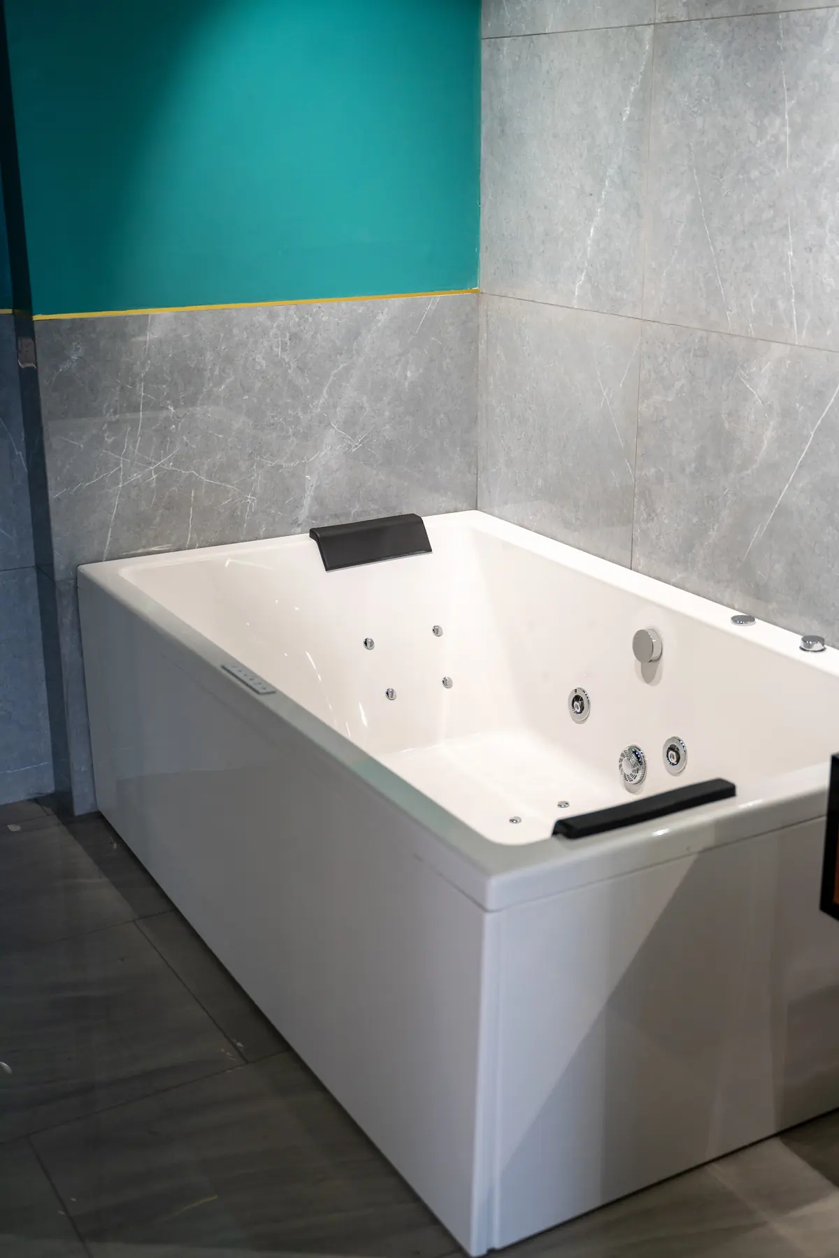 A whirlpool bathtub with headrests and jets