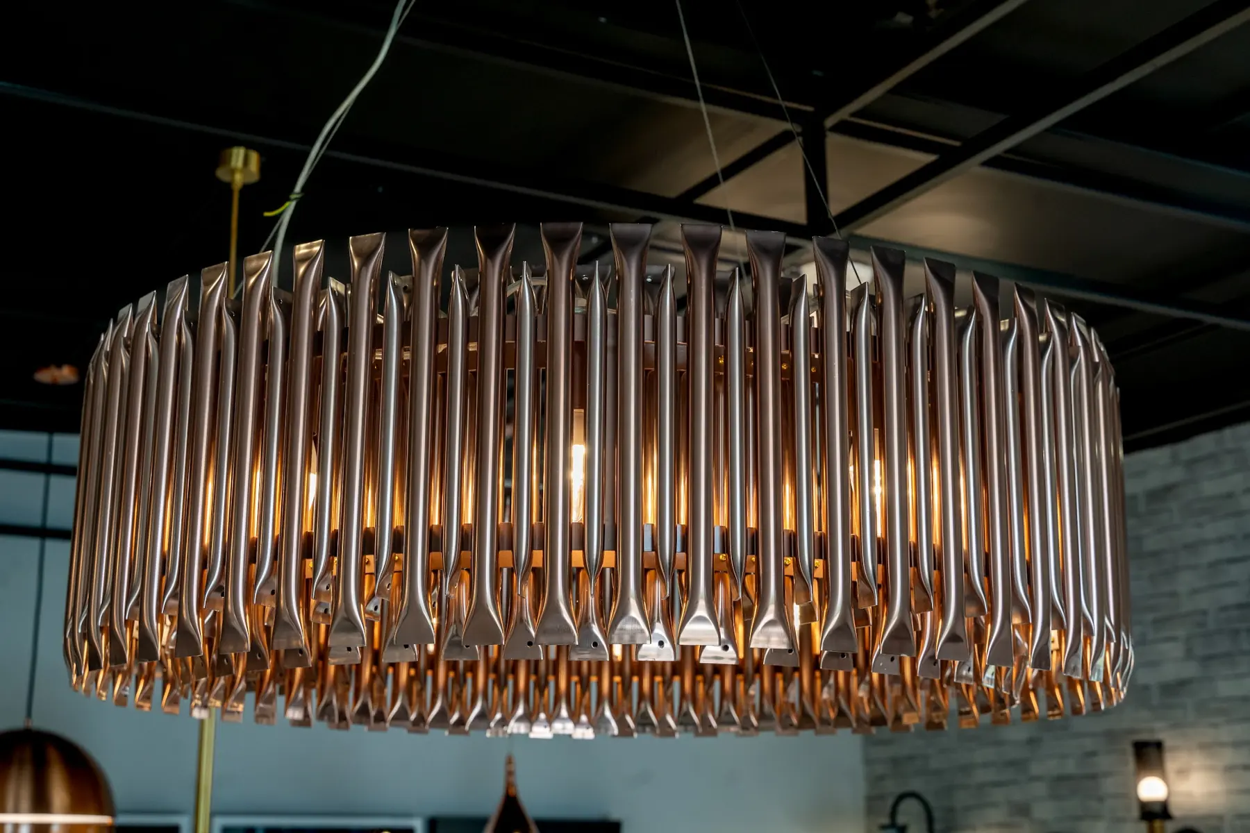 A copper ring chandelier lit above the showroom