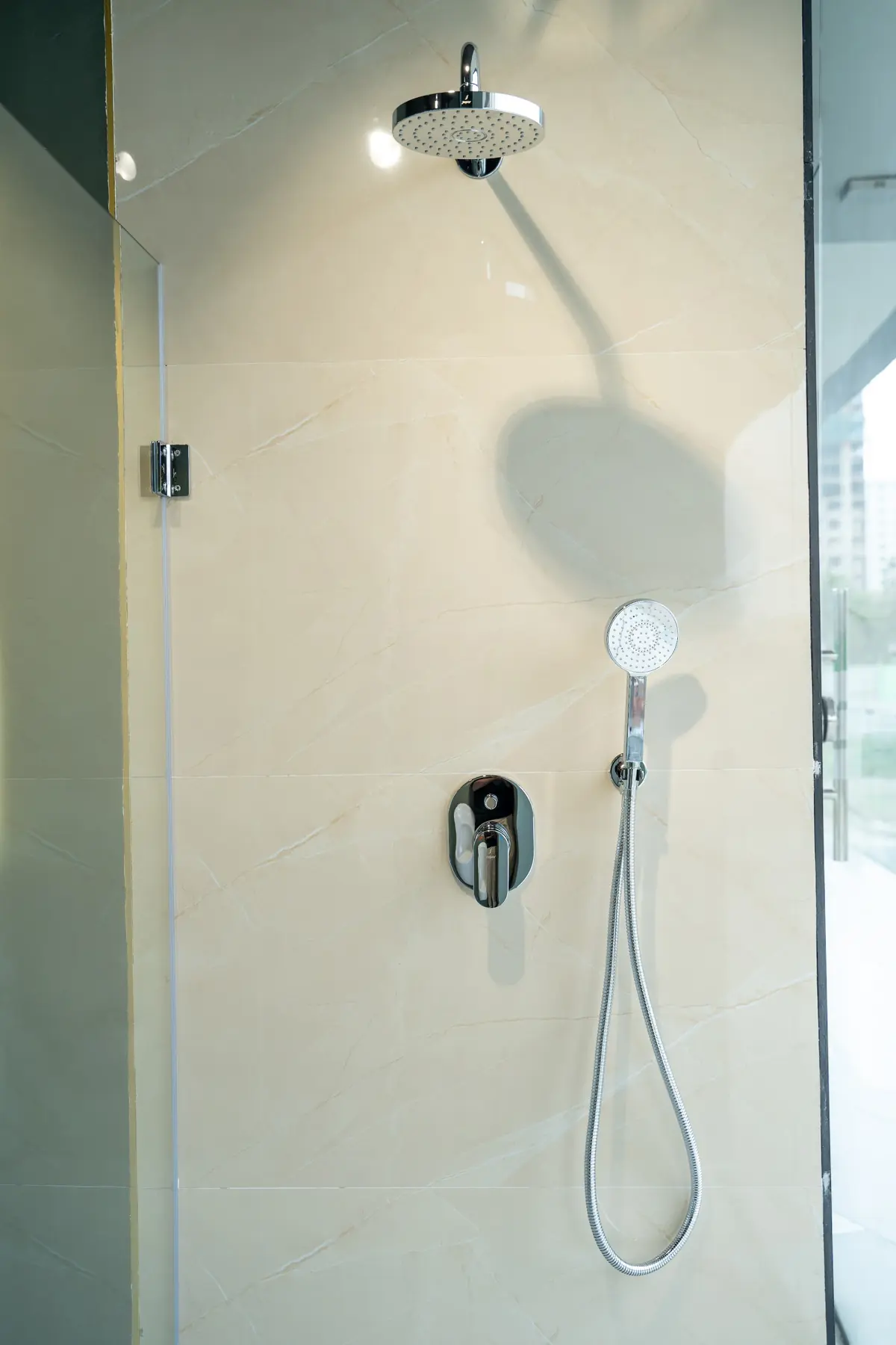 A concealed shower with an overhead rain head and hand shower