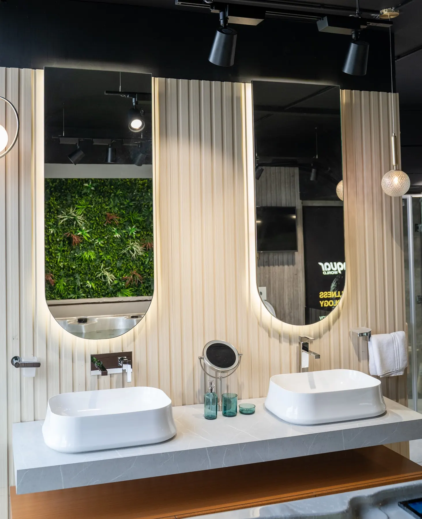 Two vessel basins below arched mirrors on a slatted wall